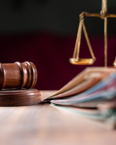 focus on hammer, group of files on judge table covered with dust - concept of pending old cases or work at judicial court.